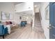 Open-concept living area with vaulted ceilings, dining space, staircase, and wood-look floors at 53 Forest Oaks Dr, Durham, NC 27705