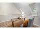 Office space with natural light, desk, and chair set on wood floor beneath a high ceiling at 53 Forest Oaks Dr, Durham, NC 27705