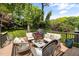 Cozy back deck featuring outdoor seating, string lights, a grill, and a view of the backyard at 5505 Knollwood Rd, Raleigh, NC 27609