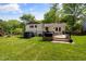 Spacious backyard featuring a deck with outdoor seating and a lush lawn at 5505 Knollwood Rd, Raleigh, NC 27609
