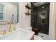 Updated bathroom featuring a sleek design, a shower with modern fixtures, and ample lighting at 5505 Knollwood Rd, Raleigh, NC 27609
