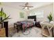 Bedroom featuring ample natural light, a ceiling fan, a TV and wooden floors at 5505 Knollwood Rd, Raleigh, NC 27609
