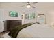 Bright bedroom featuring a ceiling fan, natural light and a wooden dresser and floors at 5505 Knollwood Rd, Raleigh, NC 27609