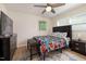 Bedroom featuring ample natural light, a ceiling fan, a TV and wooden floors at 5505 Knollwood Rd, Raleigh, NC 27609