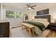 Comfortable bedroom with soft lighting, a ceiling fan, and a king-size bed creating a cozy and inviting atmosphere at 5505 Knollwood Rd, Raleigh, NC 27609
