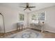 This bedroom is filled with natural light, highlighting the neutral walls and ceiling fan at 5505 Knollwood Rd, Raleigh, NC 27609