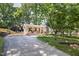 Spacious driveway leading to a charming home with a welcoming front porch at 5505 Knollwood Rd, Raleigh, NC 27609