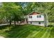 Well-manicured lawn surrounds this charming home with white siding and red brick accents at 5505 Knollwood Rd, Raleigh, NC 27609