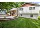 Charming two-story home with a brick foundation, white siding, and a well-maintained lawn at 5505 Knollwood Rd, Raleigh, NC 27609