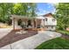 Charming home with a brick facade, covered porch, wooden posts and inviting curb appeal at 5505 Knollwood Rd, Raleigh, NC 27609