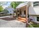 Welcoming front porch features beautiful plants, decor, and a cozy seating area at 5505 Knollwood Rd, Raleigh, NC 27609