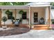 Inviting front porch with decorative plants, wooden posts, and charming decor at 5505 Knollwood Rd, Raleigh, NC 27609