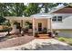 Charming front porch featuring brick facade, wood columns, and beautiful landscaping at 5505 Knollwood Rd, Raleigh, NC 27609