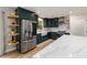Modern kitchen features stainless steel appliances, white countertops, and dark green cabinets at 5505 Knollwood Rd, Raleigh, NC 27609