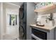 This laundry room features modern appliances, storage, and is well-lit with access to living area at 5505 Knollwood Rd, Raleigh, NC 27609