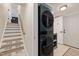 Functional laundry area with a stacked washer and dryer set and storage shelves offering convenience and organization at 5505 Knollwood Rd, Raleigh, NC 27609