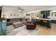 Open-concept living room and kitchen design with a large comfortable sectional and modern accents at 5505 Knollwood Rd, Raleigh, NC 27609
