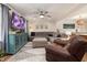 Cozy living room with a large sectional, ceiling fan, and entertainment center with TV at 5505 Knollwood Rd, Raleigh, NC 27609