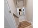 Stylish staircase with wood treads and a white-painted railing leads to the upper level of the home at 5505 Knollwood Rd, Raleigh, NC 27609