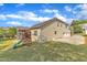 View of a well-maintained backyard featuring a playset, lawn, screened porch, and a three-car garage at 615 Prides Crsg Xing, Rolesville, NC 27571
