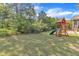 Grassy backyard features a swing set and climbing gym at 615 Prides Crsg Xing, Rolesville, NC 27571