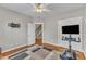 Functional bedroom with hardwood floors, equipped with a wall-mounted TV and adjacent closet space at 615 Prides Crsg Xing, Rolesville, NC 27571