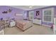 Charming bedroom featuring purple walls, carpeted floors, with a window and decorated with artwork at 615 Prides Crsg Xing, Rolesville, NC 27571
