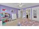 Spacious bedroom showcasing purple walls, carpeted floors, with a window and decorated with artwork at 615 Prides Crsg Xing, Rolesville, NC 27571