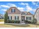 Charming two-story home with manicured lawn and stone accents, offering classic curb appeal at 615 Prides Crsg Xing, Rolesville, NC 27571
