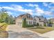 A view of this two-story residence showcasing the extended driveway and attached garages at 615 Prides Crsg Xing, Rolesville, NC 27571
