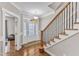 Inviting foyer with hardwood floors, staircase with wooden railing, and a stylish front door at 615 Prides Crsg Xing, Rolesville, NC 27571