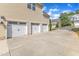 Three car garage with white garage doors and long driveway at 615 Prides Crsg Xing, Rolesville, NC 27571