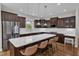 Modern kitchen features a spacious island, stainless steel appliances, and ample storage in dark wood cabinetry at 615 Prides Crsg Xing, Rolesville, NC 27571