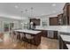Open kitchen design with an island, stainless steel appliances, and seamless flow to the dining area at 615 Prides Crsg Xing, Rolesville, NC 27571