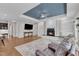 Open-concept living room boasts hardwood floors, fireplace, and ample natural light at 615 Prides Crsg Xing, Rolesville, NC 27571