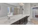 Bathroom with double sink vanity, tiled floors, and a walk-in shower at 615 Prides Crsg Xing, Rolesville, NC 27571