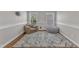 Cozy sitting room with natural light, comfortable seating, and a plush rug for relaxation and leisure at 615 Prides Crsg Xing, Rolesville, NC 27571