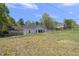 Large backyard with green grass, fenced perimeter, and mature trees beyond at 629 Houndsditch Cir, Wake Forest, NC 27587