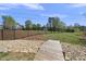 Landscaped backyard featuring a rock garden, footbridge, and black metal fence at 629 Houndsditch Cir, Wake Forest, NC 27587
