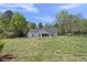 Expansive backyard with black metal fence, offering privacy and security, with a beautiful lawn at 629 Houndsditch Cir, Wake Forest, NC 27587
