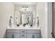 Bathroom featuring double sinks, vanity, granite countertops, and decorative mirror at 629 Houndsditch Cir, Wake Forest, NC 27587