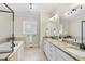 Bathroom featuring double sink vanity, granite countertop, soaking tub and glass-enclosed shower at 629 Houndsditch Cir, Wake Forest, NC 27587