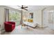 Cozy bedroom space with large window, seating, and modern ceiling fan at 629 Houndsditch Cir, Wake Forest, NC 27587