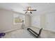 Neutral bedroom featuring exercise equipment, ceiling fan, and a bright window at 629 Houndsditch Cir, Wake Forest, NC 27587