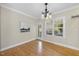 Bright dining room with hardwood floors, large windows, and access to outdoor patio at 629 Houndsditch Cir, Wake Forest, NC 27587