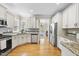 Modern kitchen with stainless steel appliances, granite countertops, and ample cabinet space at 629 Houndsditch Cir, Wake Forest, NC 27587