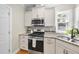 Well-equipped kitchen with stainless steel range, ample counter space, and tile backsplash at 629 Houndsditch Cir, Wake Forest, NC 27587