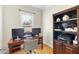 Home office with wood floors and shelving next to a window providing natural light at 629 Houndsditch Cir, Wake Forest, NC 27587