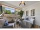 Relaxing screened-in porch with comfortable outdoor seating, views of the backyard, and a ceiling fan for added comfort at 629 Houndsditch Cir, Wake Forest, NC 27587