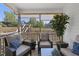 Inviting screened porch with comfortable seating and views of the landscaped backyard and neighborhood at 629 Houndsditch Cir, Wake Forest, NC 27587
